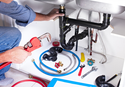 plumber-fixing-sink-pipes